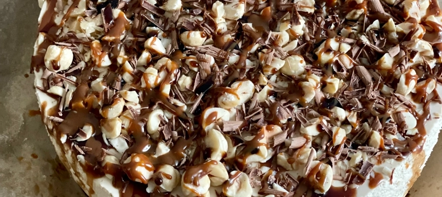 Tarta mousse de café con cobertura de avellanas, chocolate y dulce de leche.